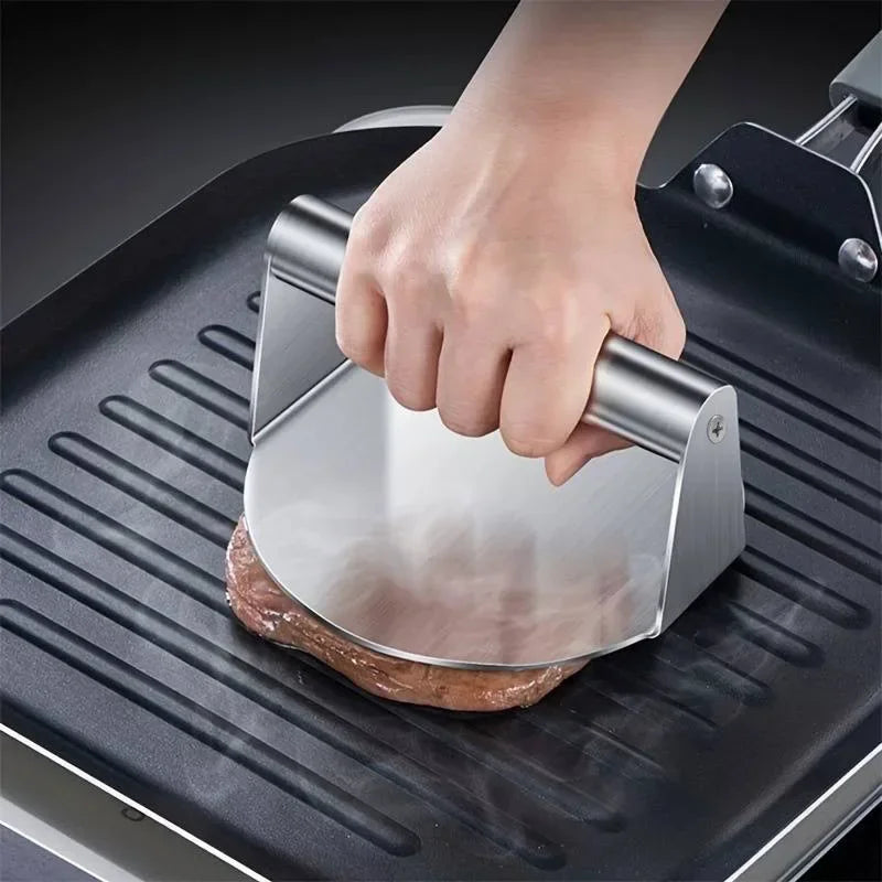 Smashing a burger patty on a hot plate